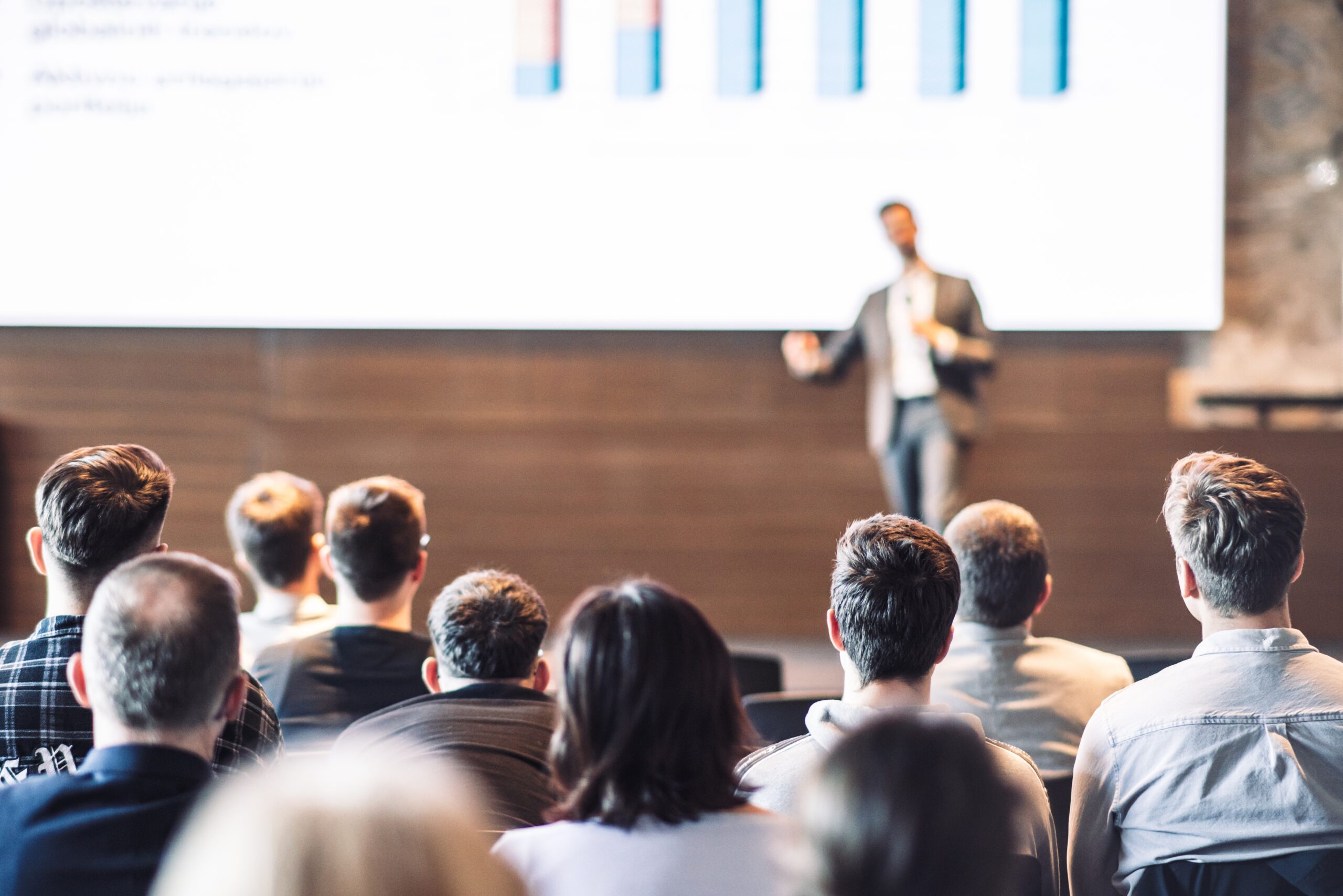 A person on stage giving a presentation